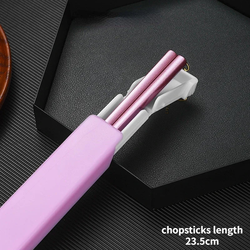 Set of pink kawaii chopsticks with a white holder on a black textured surface.