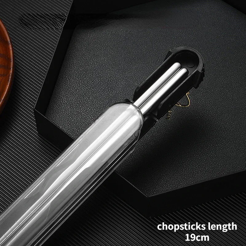Set of silver kawaii chopsticks with a black holder on a dark surface