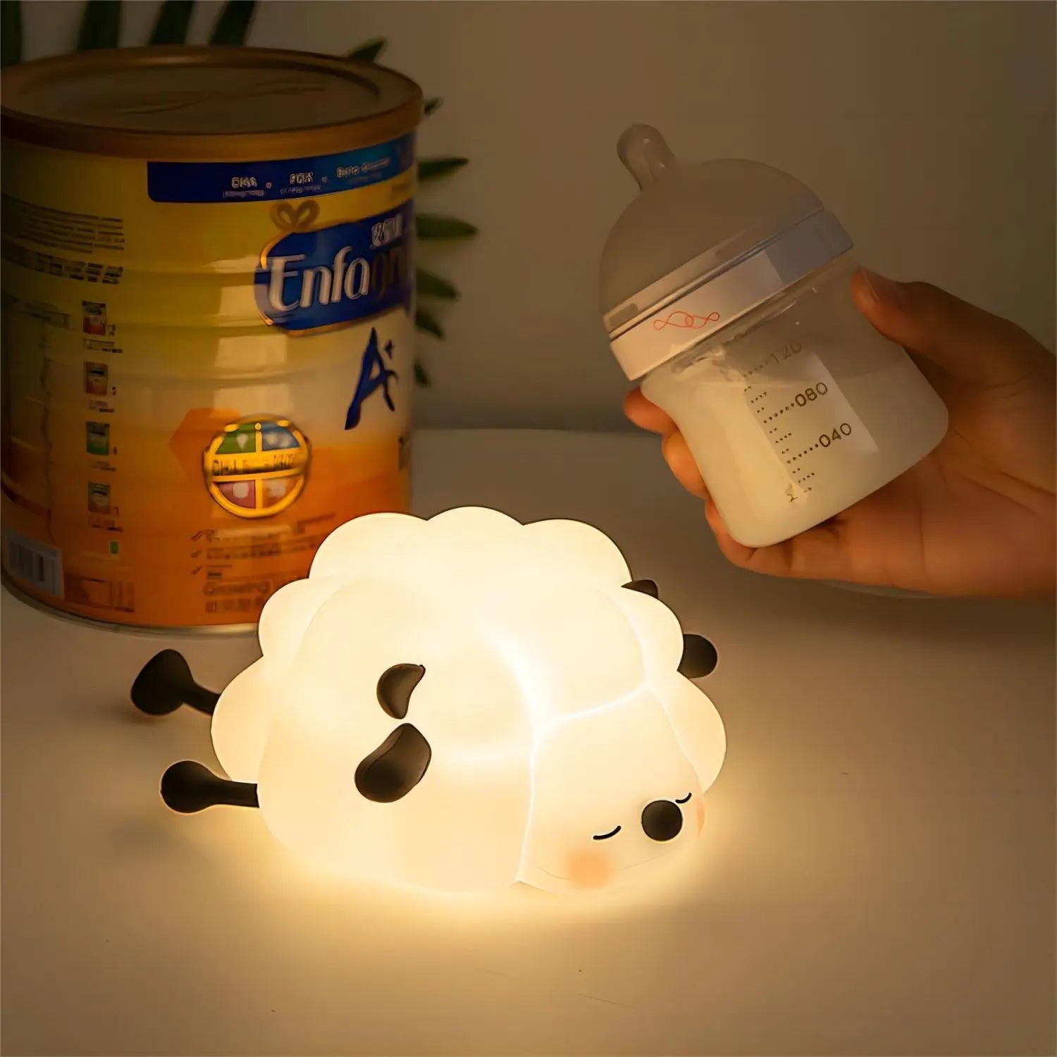 Sheep-shaped kawaii night light with Enfa baby formula can and bottle in the background