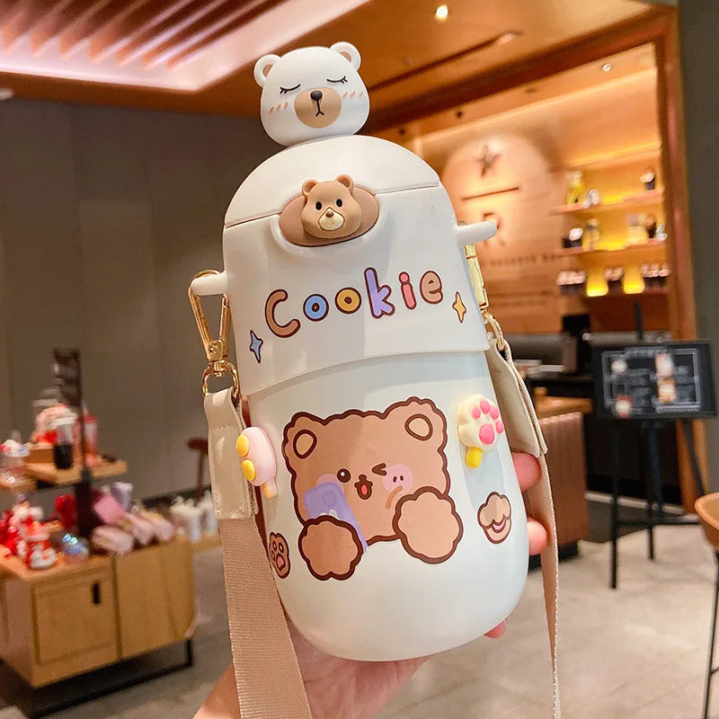 Cartoon-themed kawaii water bottle with bear design held in a casual setting