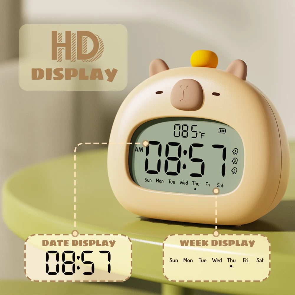 Cute animal-shaped kawaii digital clock with temperature display on a green surface