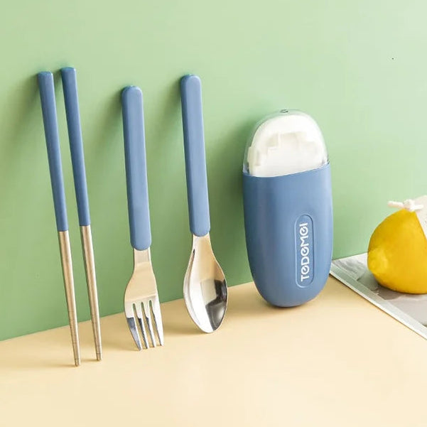 Set of blue kawaii utensils with a container on a green background