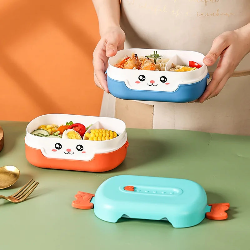 Two cartoon-style kawaii bento boxes with food on a green table, one being held by a person.