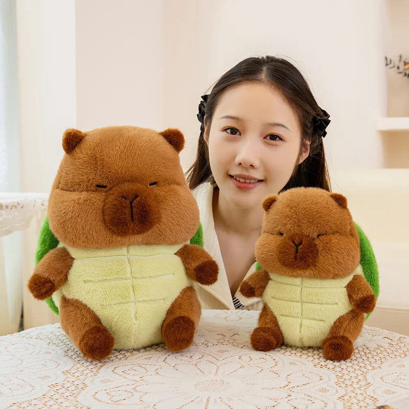 Woman holding two brown kawaii plush toys resembling animals on a lace tablecloth.