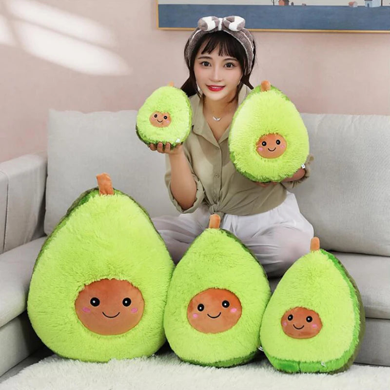 Person holding kawaii plush avocado toys on a couch