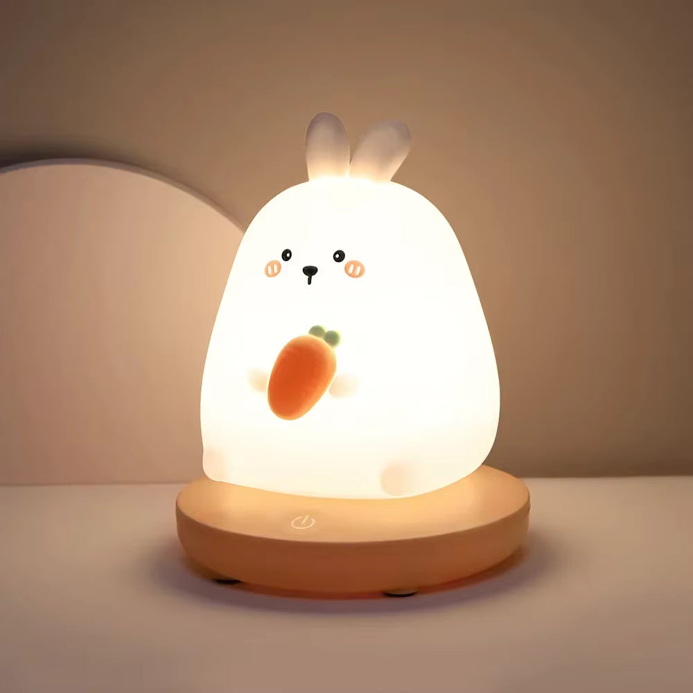 Cute rabbit-shaped night light with a carrot on a neutral background