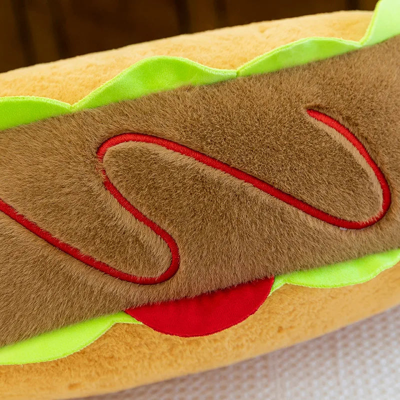 Close-up of a kawaii plush toy resembling a hot dog with bun, sausage, and toppings.