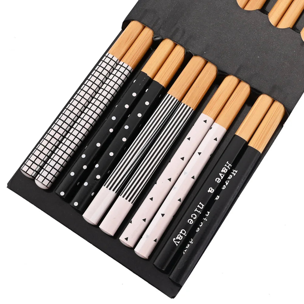 Set of kawaii chopsticks in black cases on a white background