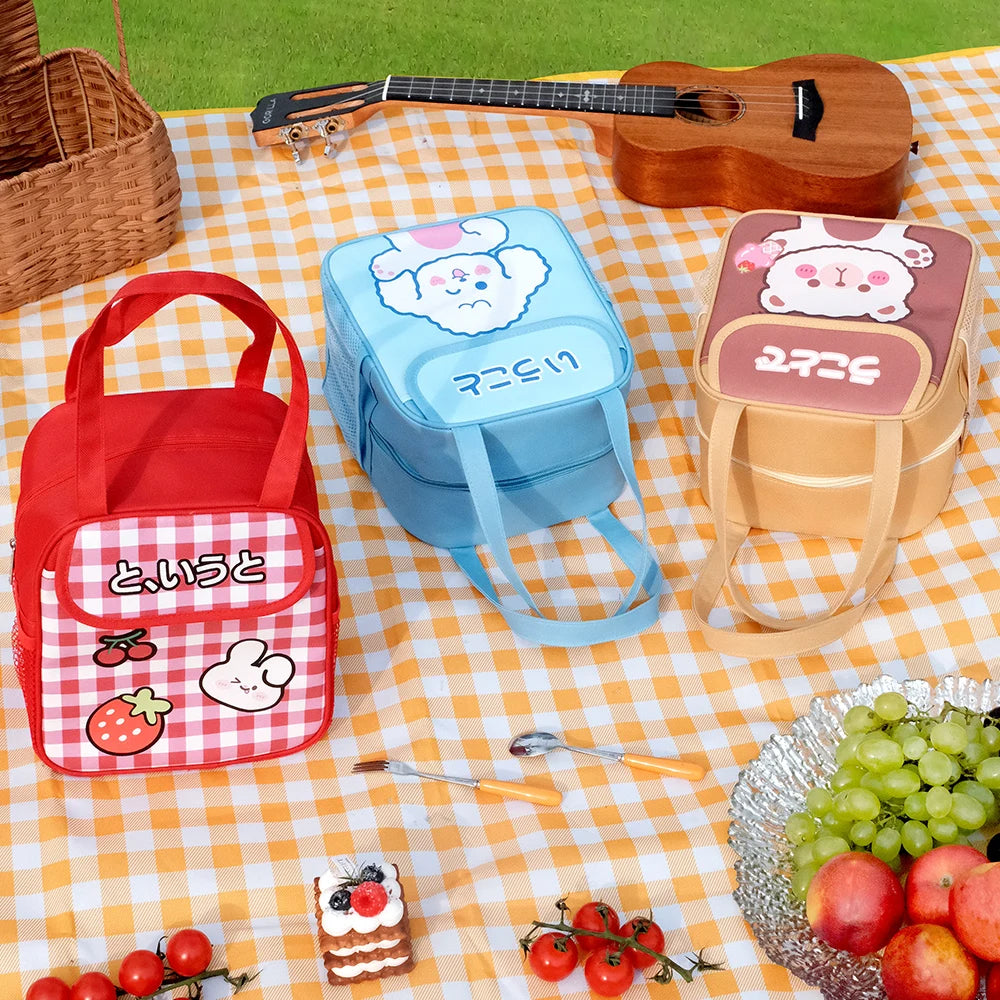 Three cartoon-themed kawaii lunch bags on a checkered tablecloth with fruits and a guitar in the background.