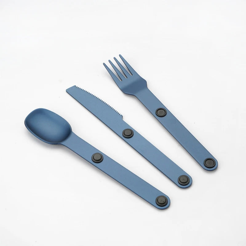 Set of blue kawaii utensils including a spoon, knife, and fork on a white background