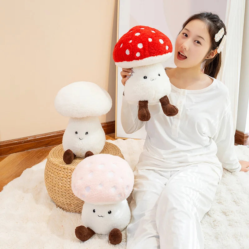 Woman holding a kawaii plush mushroom toy in a room with other plush mushrooms.
