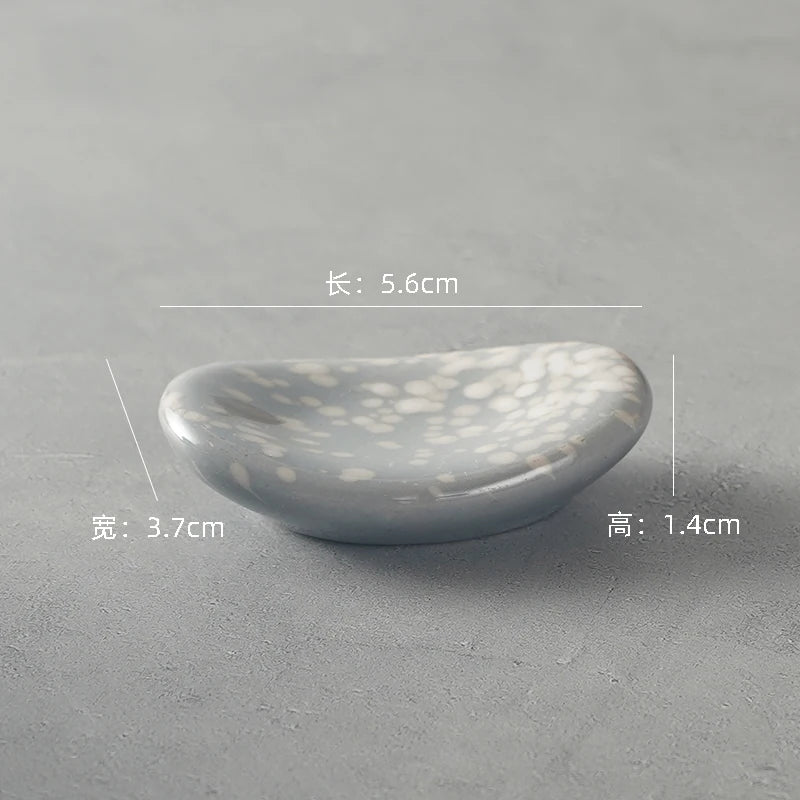 A gray kawaii chopstick holder on a table