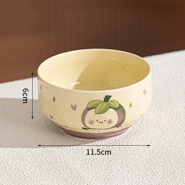 Ceramic kawaii bowl with a cartoon design on a textured surface, showing dimensions.