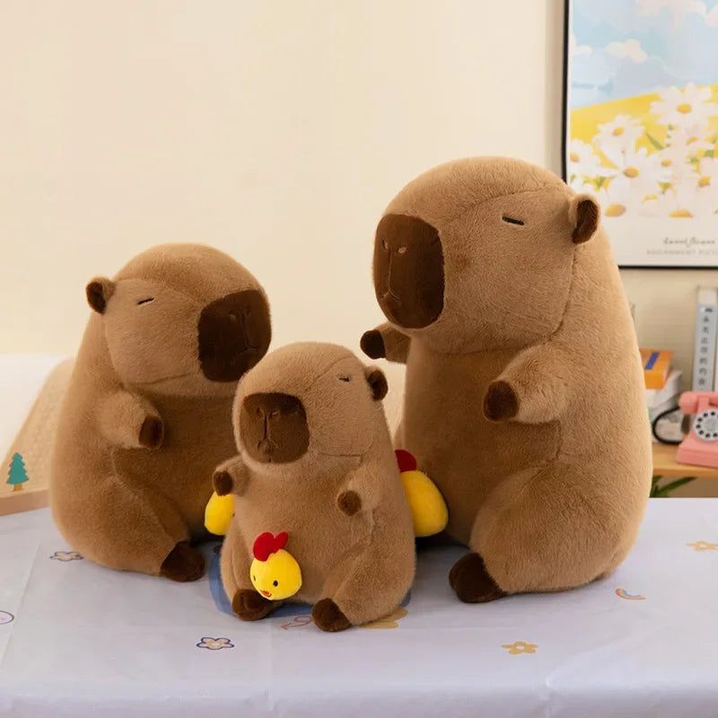 Three brown kawaii plush toys resembling animals on a light-colored surface.