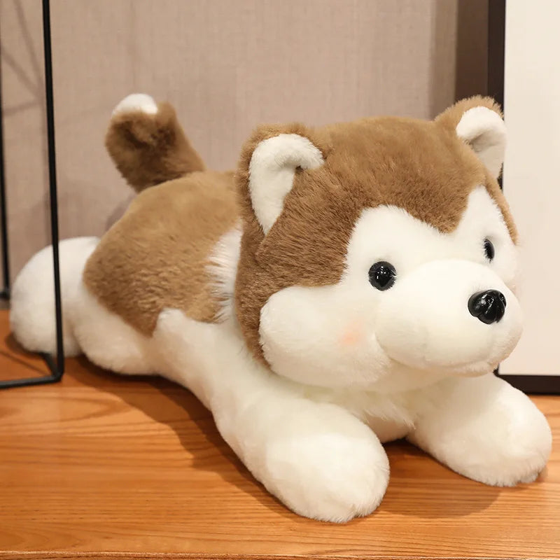 Plush kawaii toy dog with brown and white fur on a wooden surface