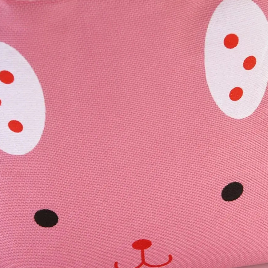 Pink fabric with cartoon face design of a kawaii lunch bag