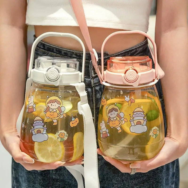 Two transparent kawaii water bottles with cartoon designs held by a person.