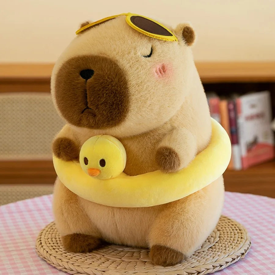 Kawaii plush toy bear with a yellow life buoy and duck toy on a table