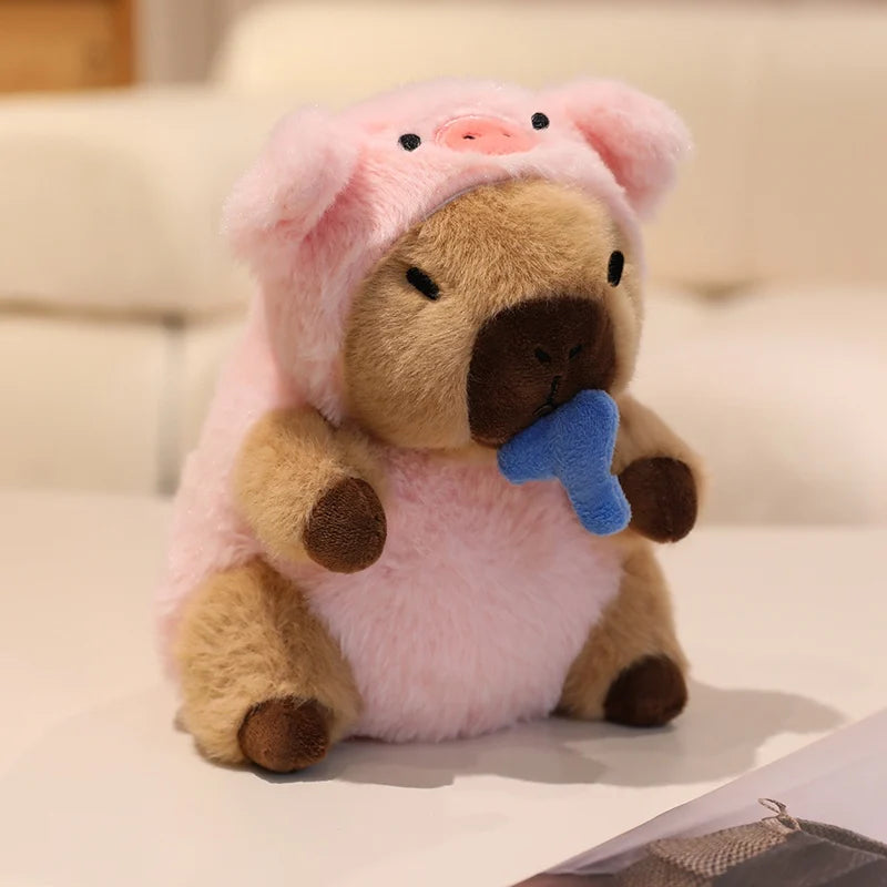 Kawaii plush toy bear wearing a pink pig costume on a light background