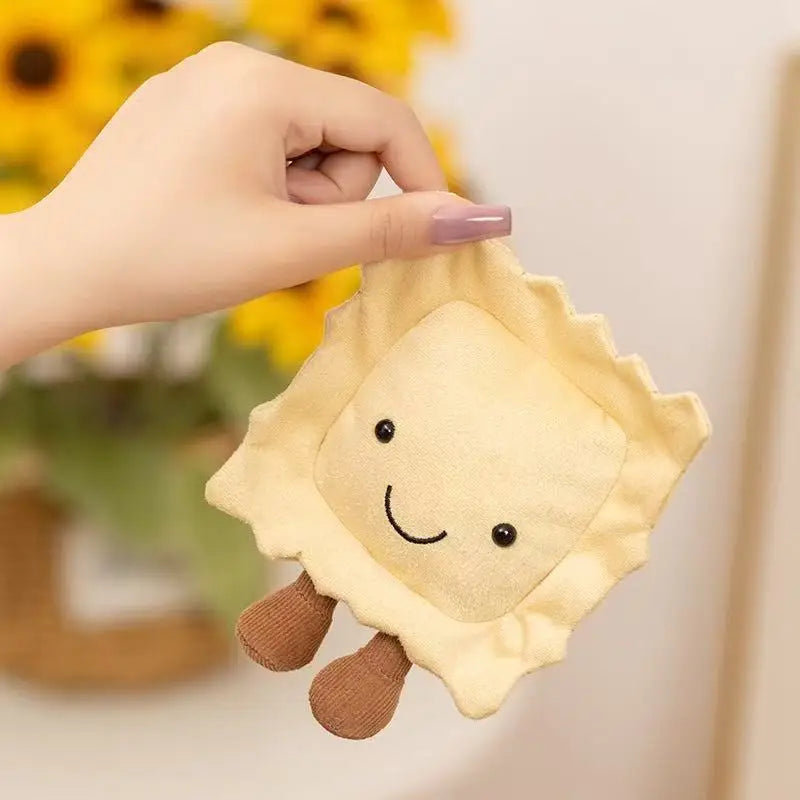 Hand holding a kawaii plush toy shaped like a smiley face shell with a blurred background of sunflowers.
