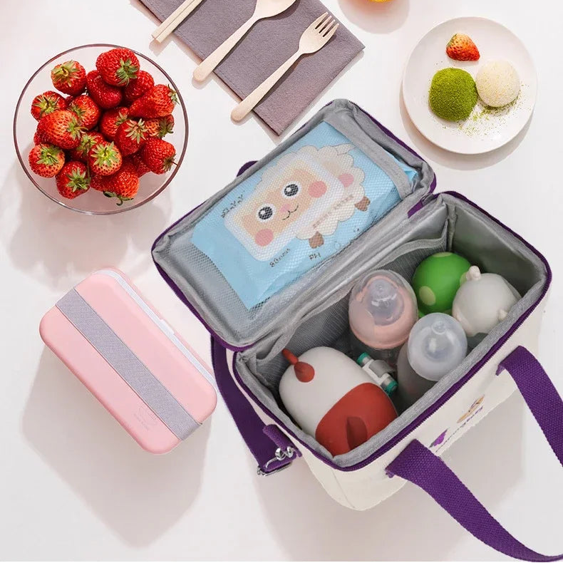 Open purple kawaii lunch bag with food items on a white surface with fruits and utensils.