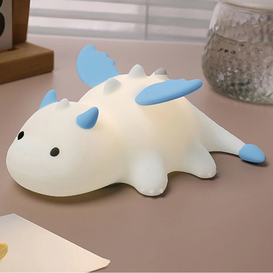 Cute dragon-shaped kawaii night light on a table