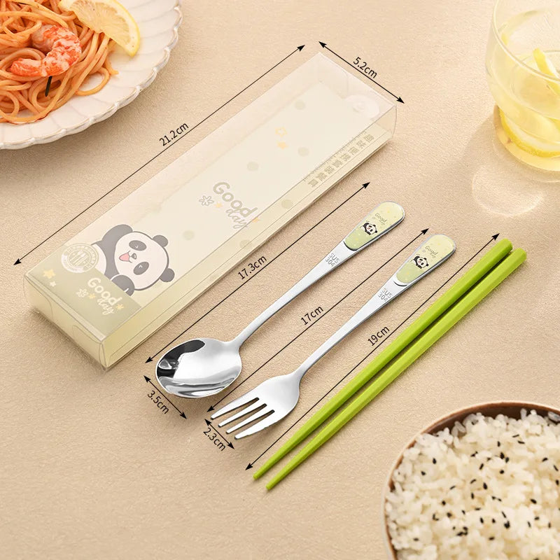 Set of kawaii utensils including spoon, fork, and green chopsticks with packaging on a beige surface.