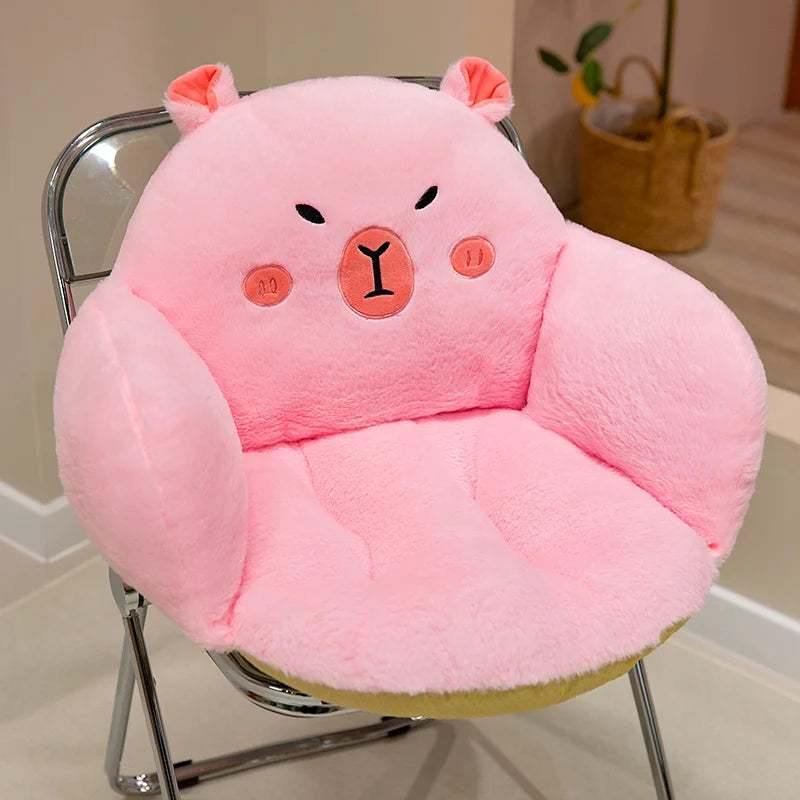 Pink bear-shaped kawaii cushion on a chair with a neutral background