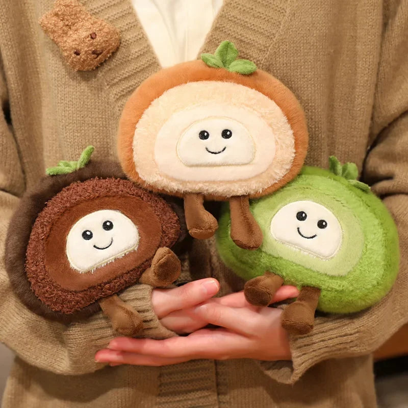 Three kawaii plush toys resembling acorns and a brussels sprout held by a person wearing a brown sweater.