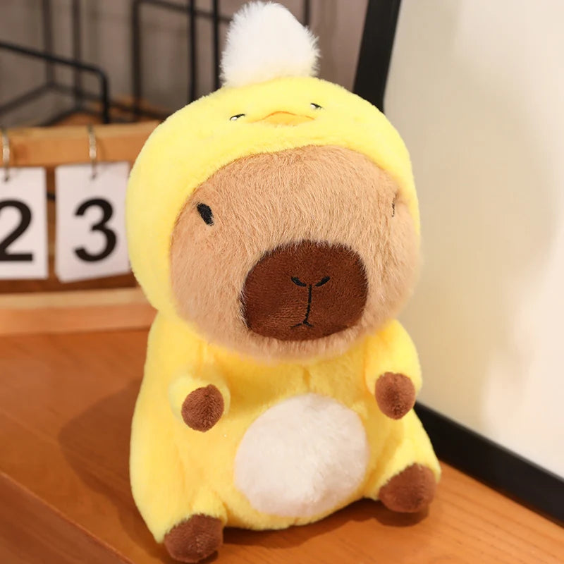 Kawaii plush toy resembling a character in a yellow outfit with brown accents on a wooden surface.