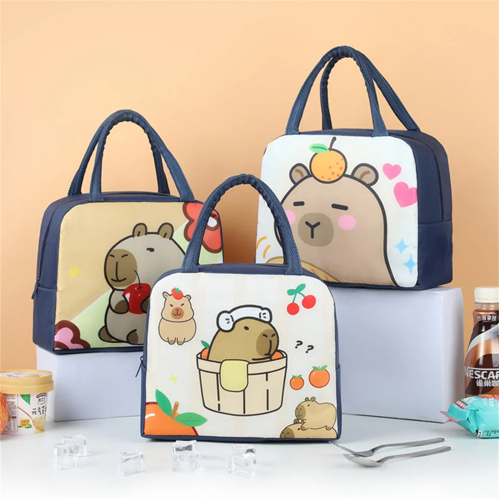 Three cartoon-themed kawaii lunch bags with animal illustrations on a beige background.