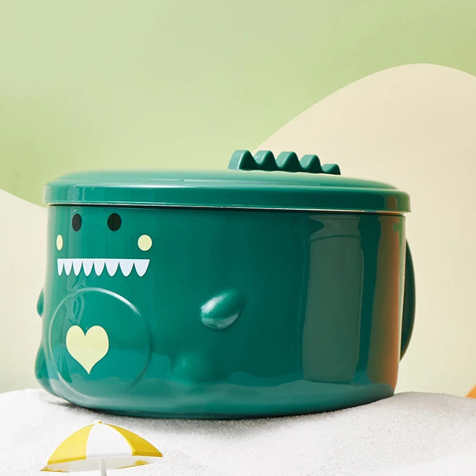 A green monster themed kawaii ramen bowl sitting on the table