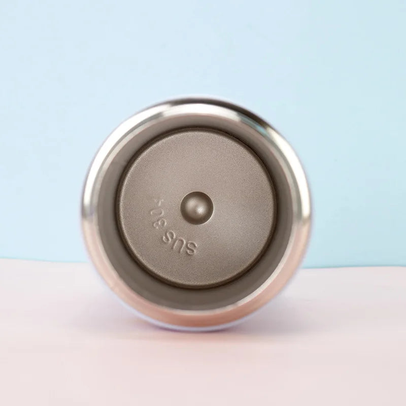 Metallic kawaii water bottle with 'sus' branding on a light blue background