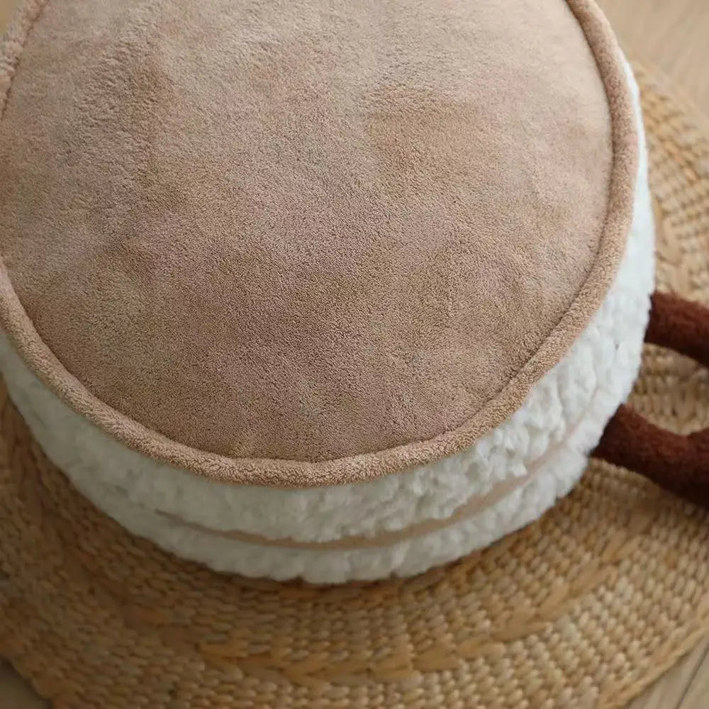 Close-up of a textured brown and white kawaii cushion on a woven surface
