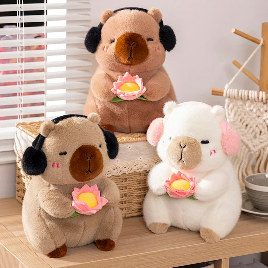 Three kawaii plush toys resembling animals with flowers on a wooden surface.