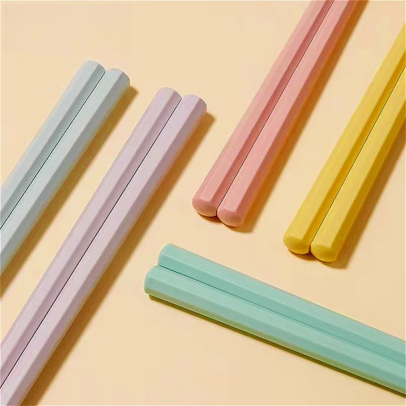 Set of colorful kawaii chopsticks on a beige background