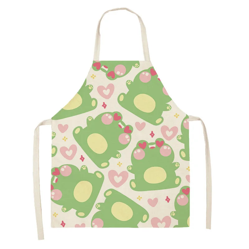 Children's kawaii apron with green frog pattern on a white background