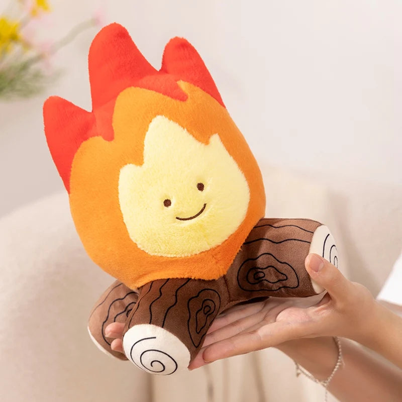 Kawaii plush toy shaped like a flame held in a hand with a soft focus background