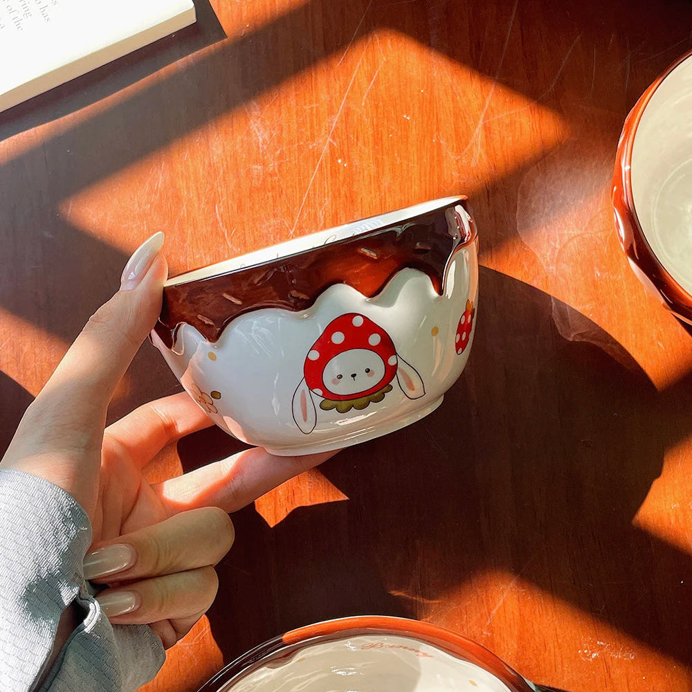 A woman holding a kawaii ramen bowl with a rabbit designed on it
