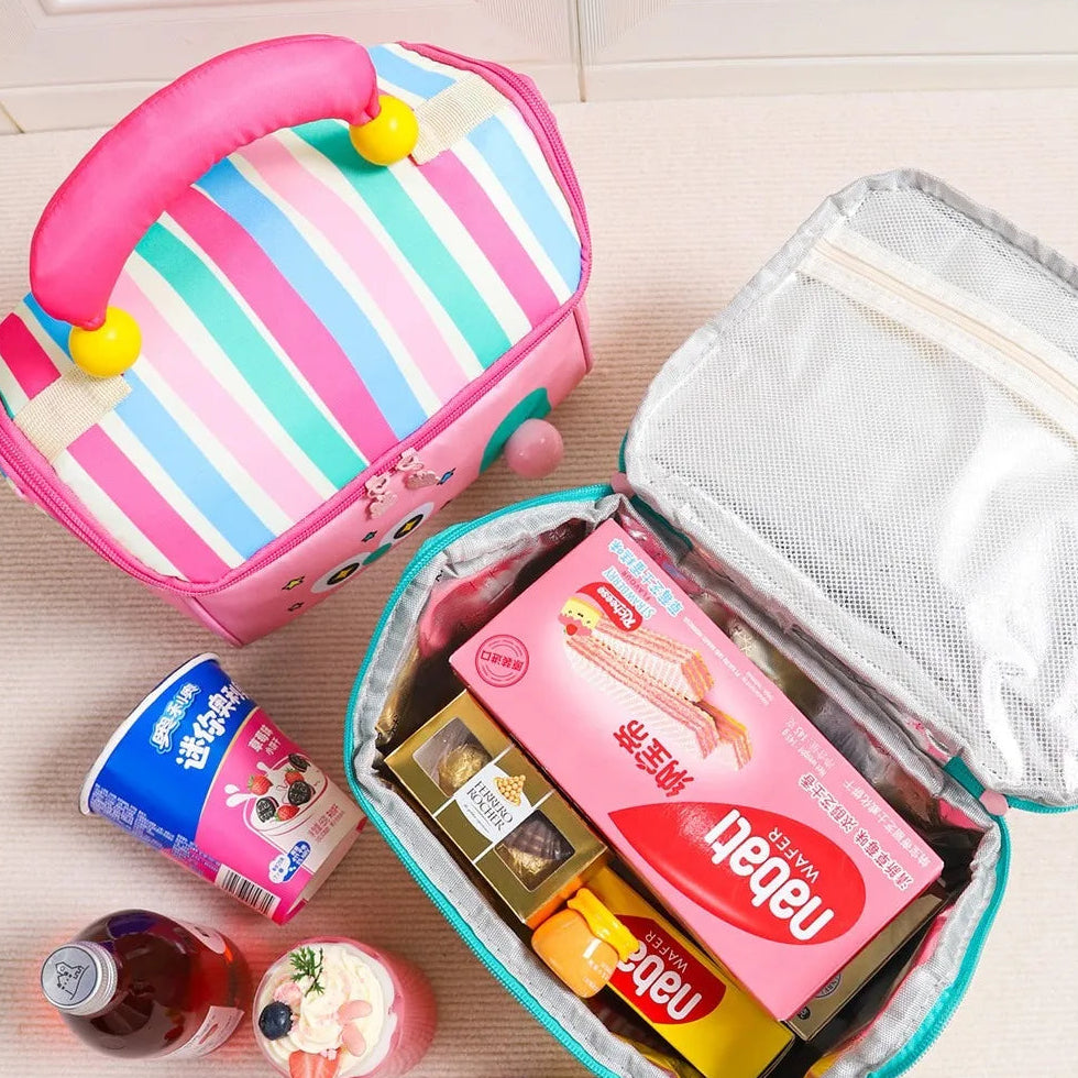 Kawaii lunch bag with snacks and drinks on a light wooden surface