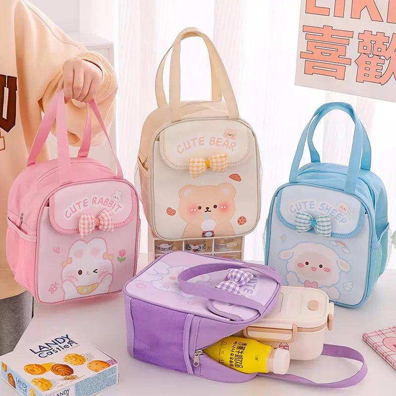 Set of cute animal-themed kawaii lunch bags on a table with a person partially visible.