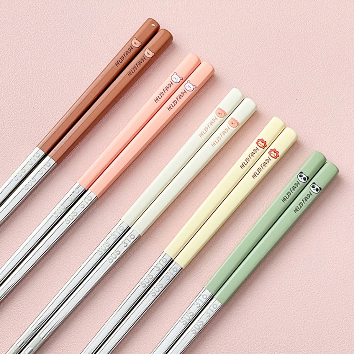 Set of colorful kawaii chopsticks on a pink background