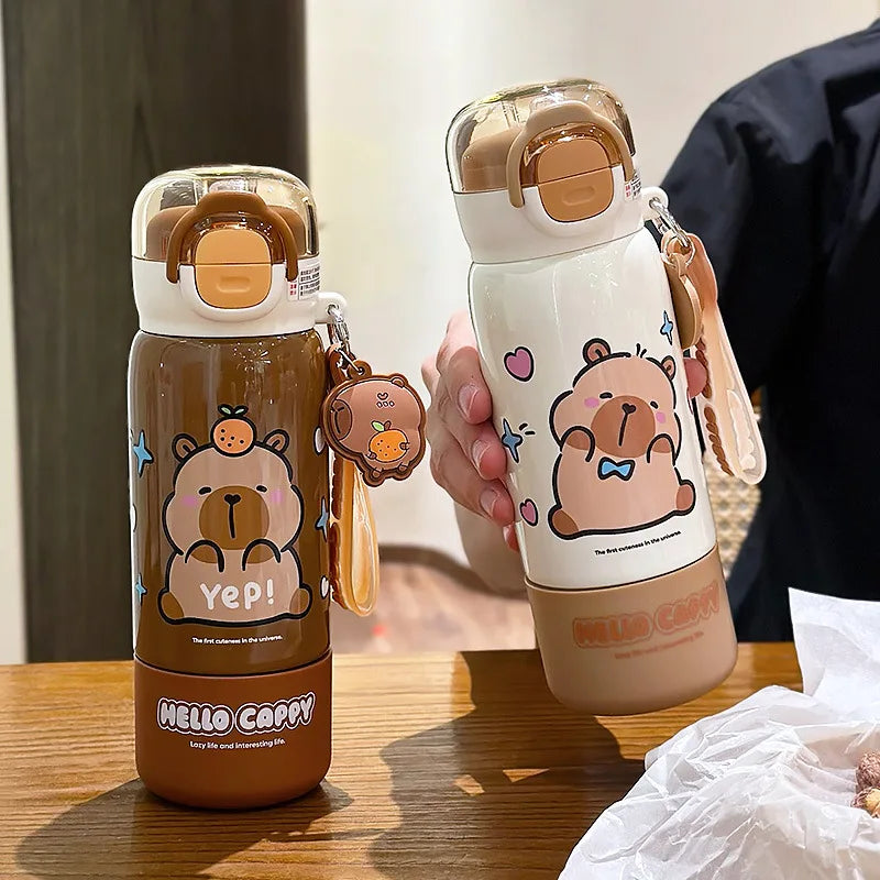 Two cartoon-themed kawaii water bottles with bear designs on a wooden surface.