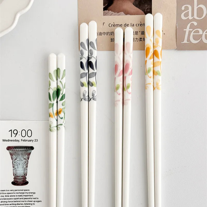 Set of floral-patterned kawaii chopsticks on a magazine background