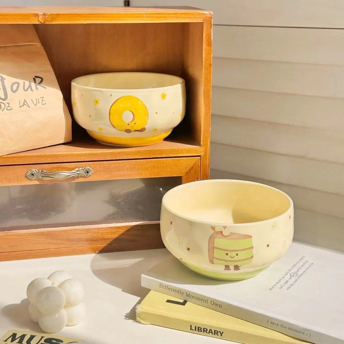 Two kawaii bowls with cartoon designs on them
