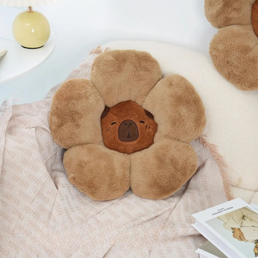 Floral-shaped kawaii pillow with bear face design on a soft surface