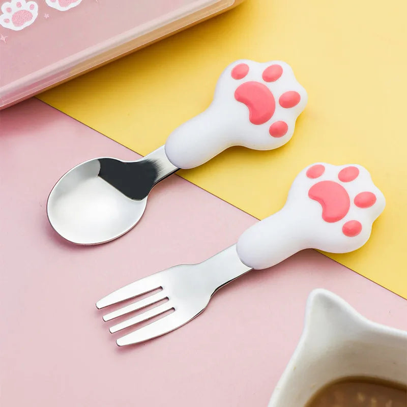 Kawaii utensils with paw-shaped handles on a pink and yellow background