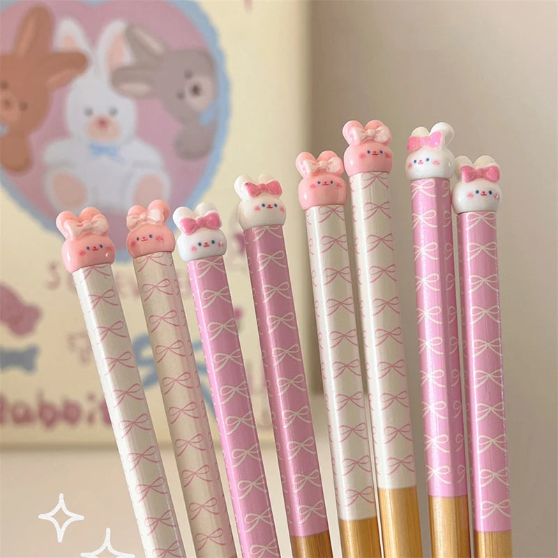 Set of decorative kawaii chopsticks with cartoon animal ends on a light background