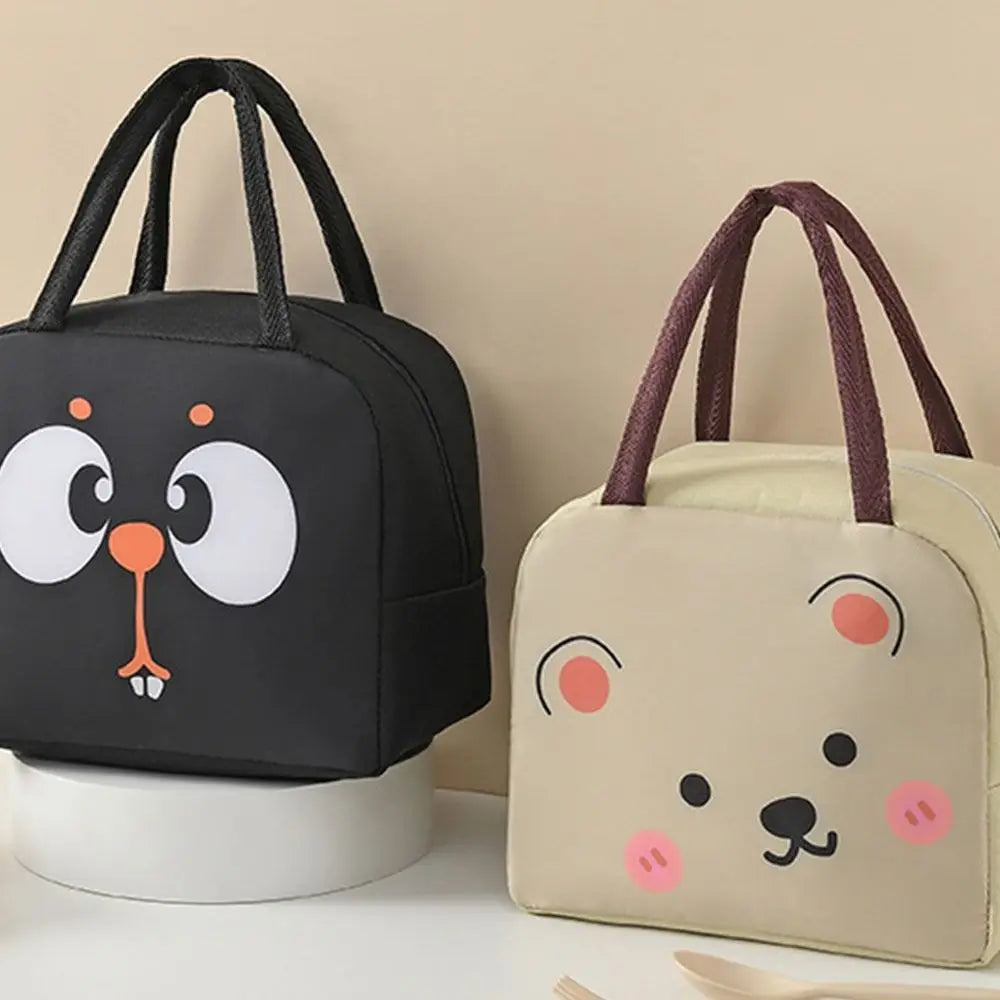Two kawaii lunch bags with animal face designs on a beige background