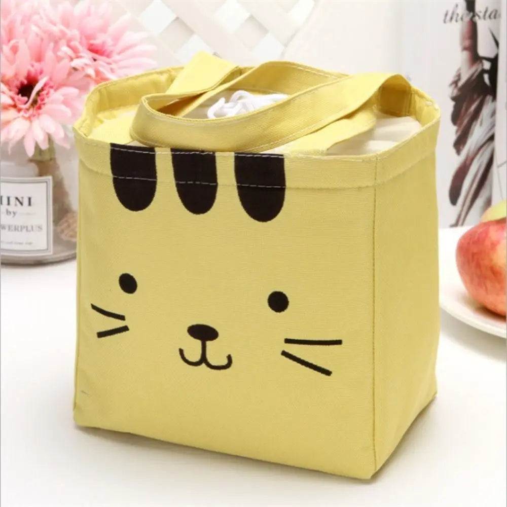 Yellow kawaii bag with a cat face design on a white surface